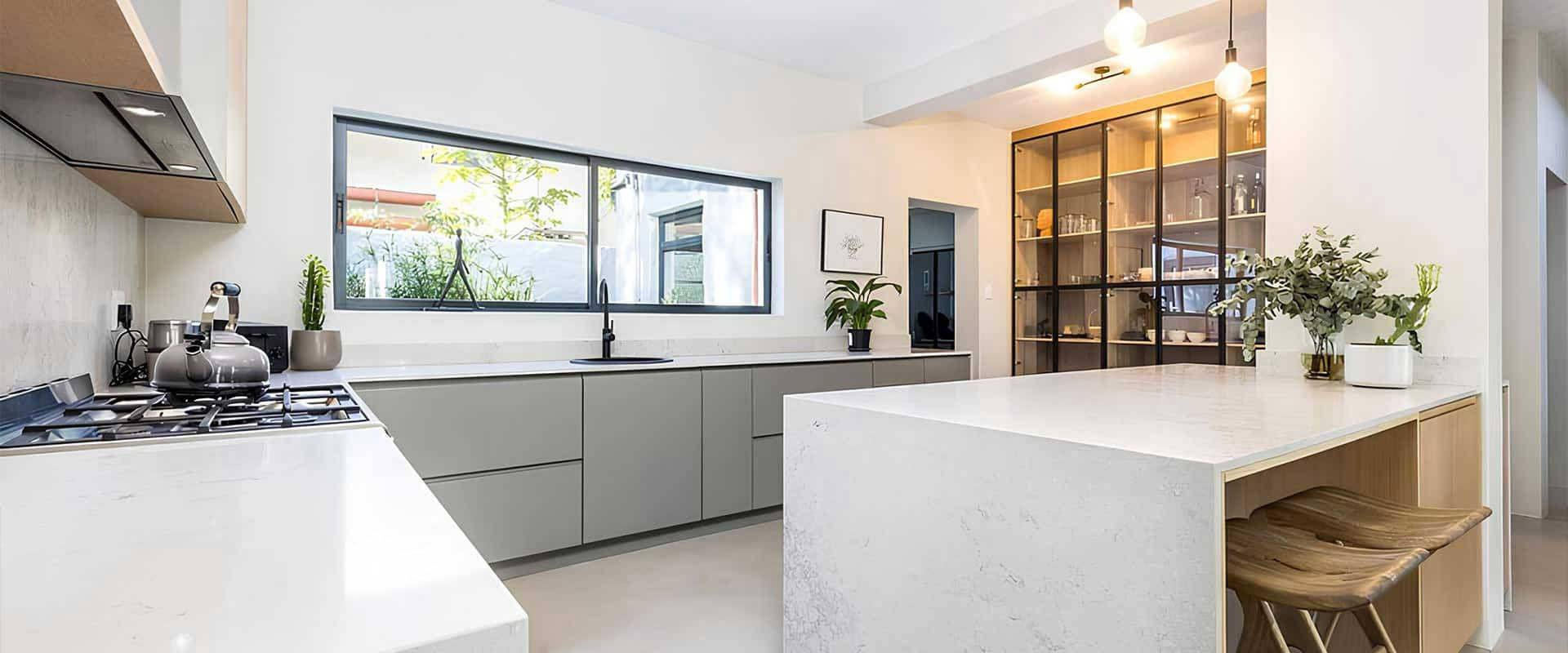 Contemporary kitchen with large island and glass display cabinet